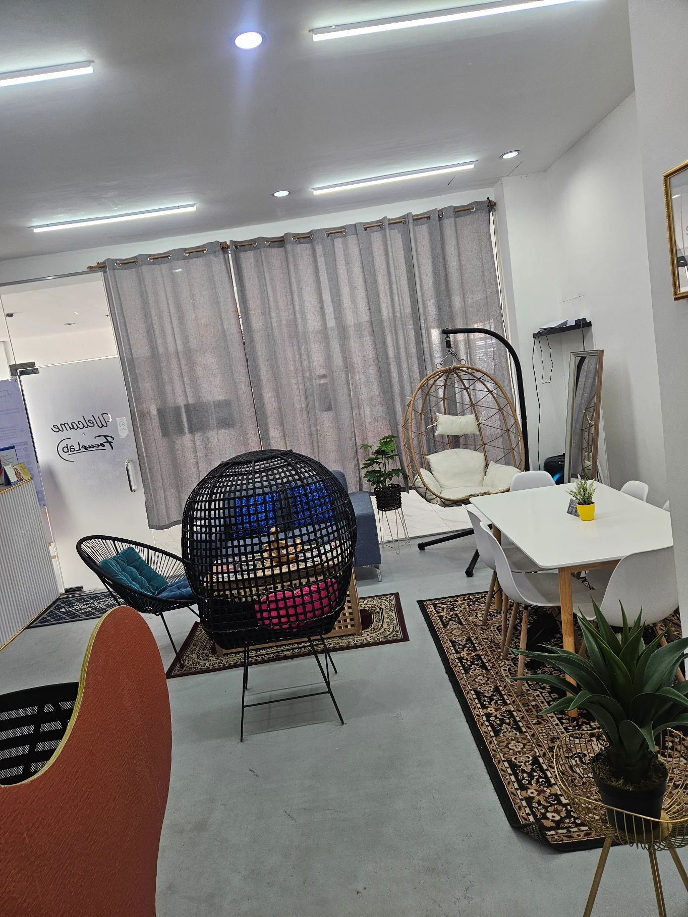 FocusLab coworking space lounge area with hanging egg chair and dining table, photo from a Google review by May Mary I.
